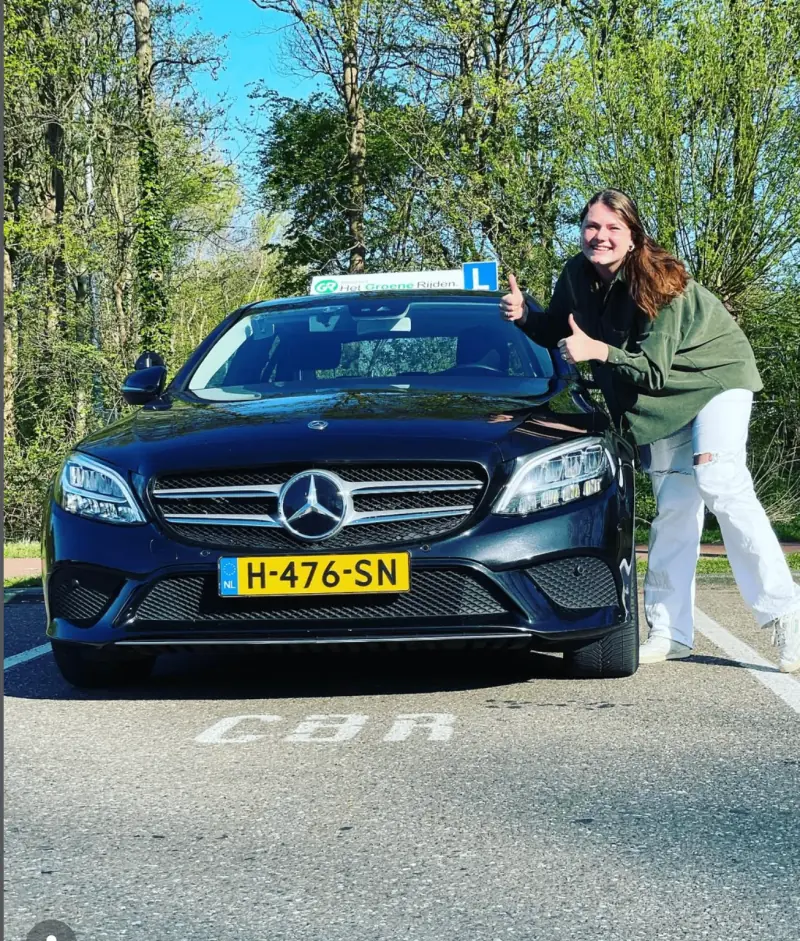 Driving School Leiden student celebrating her Dutch driving licence after English driving lessons in Leiden