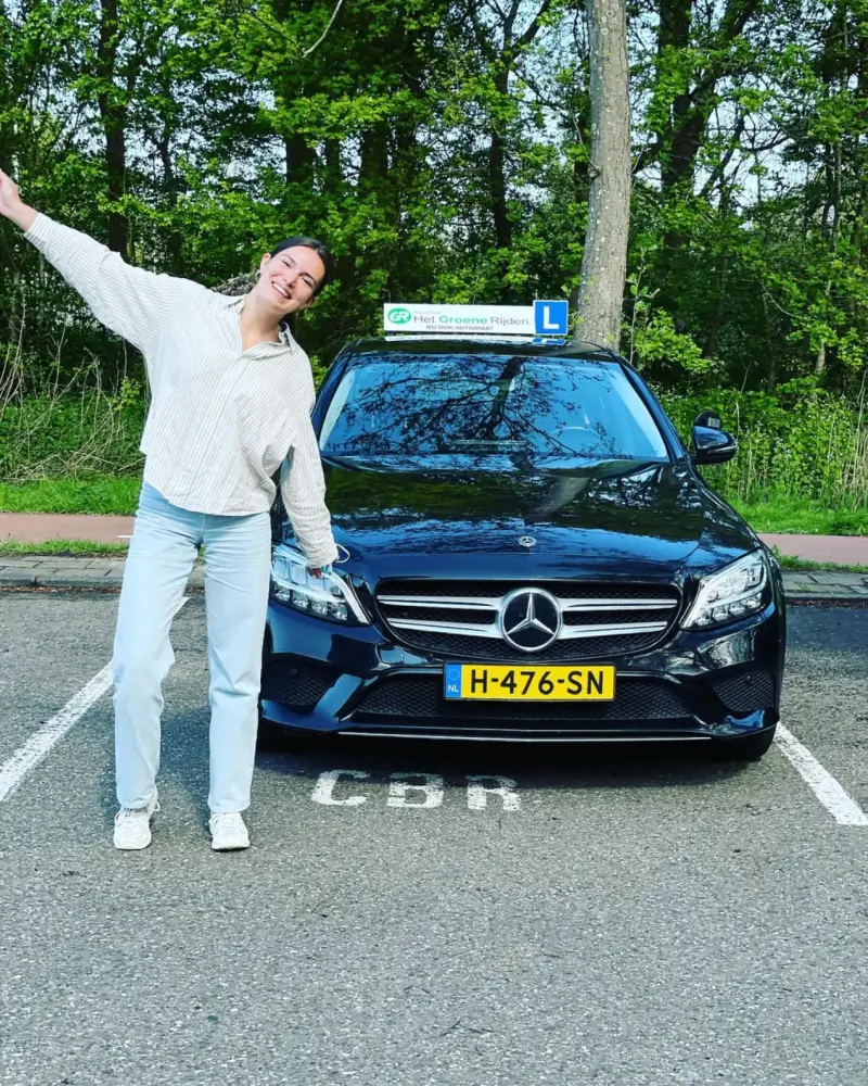 Leiden University student with her CBR pass certificate after English driving lessons at Driving School Leiden
